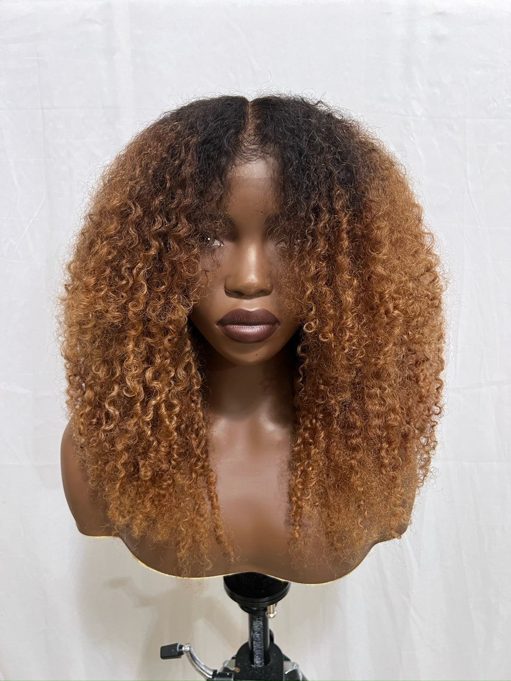hand bleached color, curtain bangs and is crafted from 100% human kinky hair