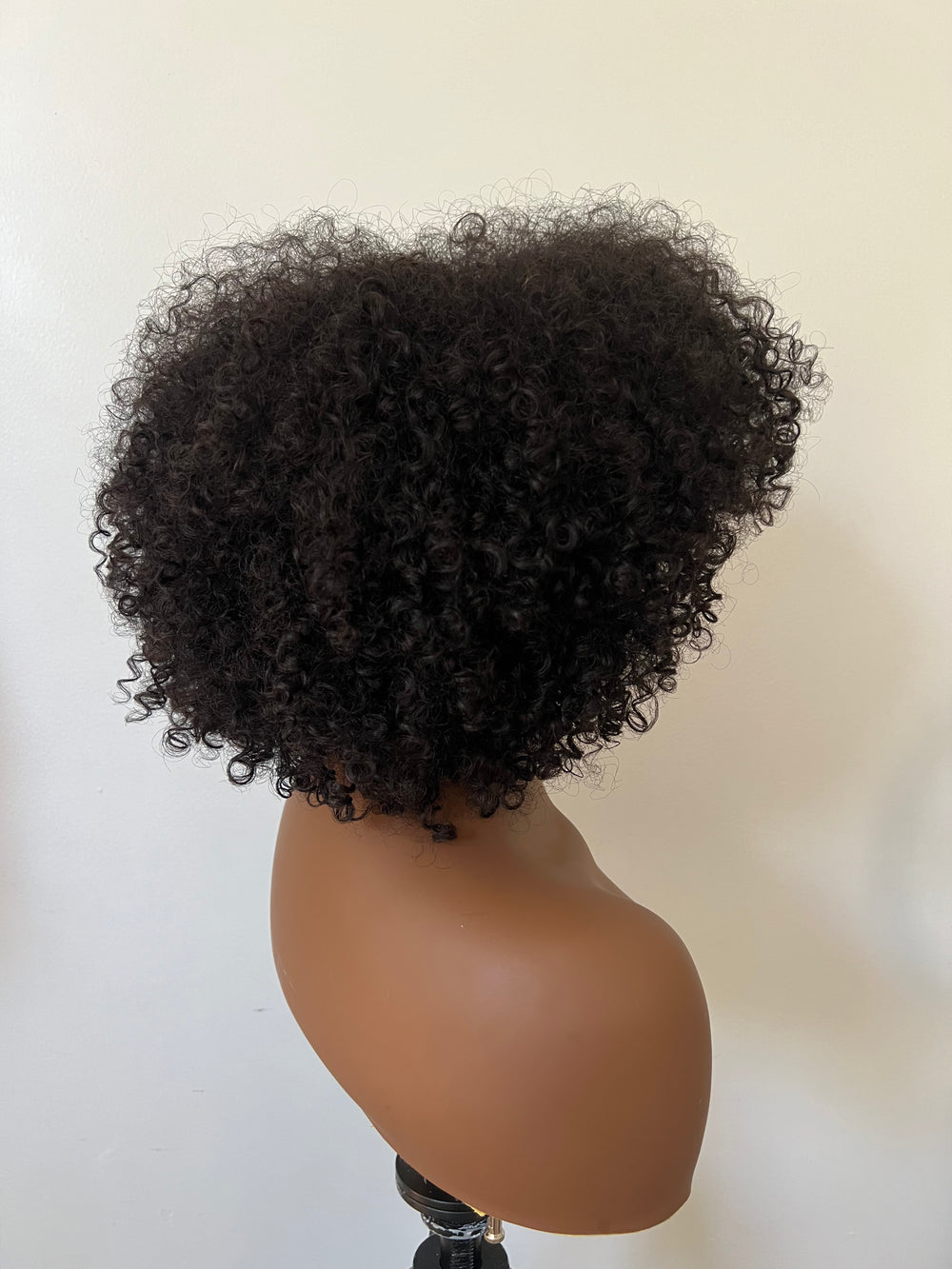 14-inch pre-styled unit features curly textured hair. The 200% density