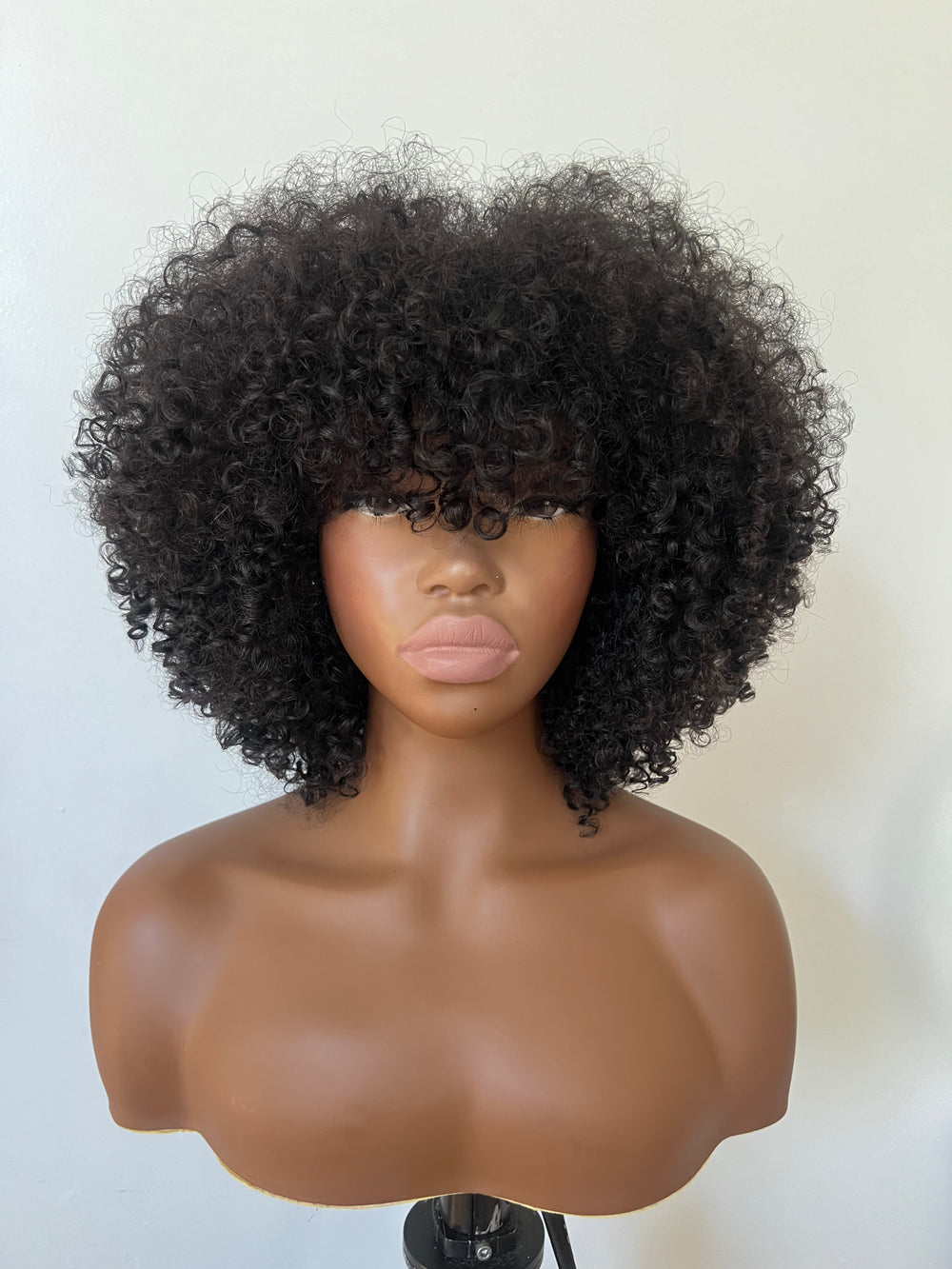 14-inch pre-styled unit features curly textured hair. The 200% density