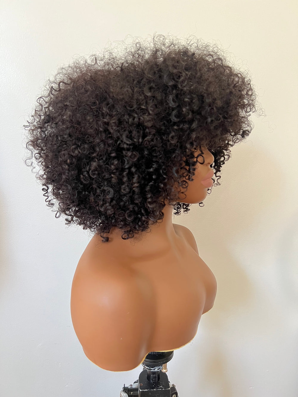 14-inch pre-styled unit features curly textured hair. The 200% density