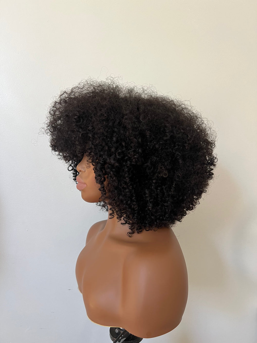 14-inch pre-styled unit features curly textured hair. The 200% density