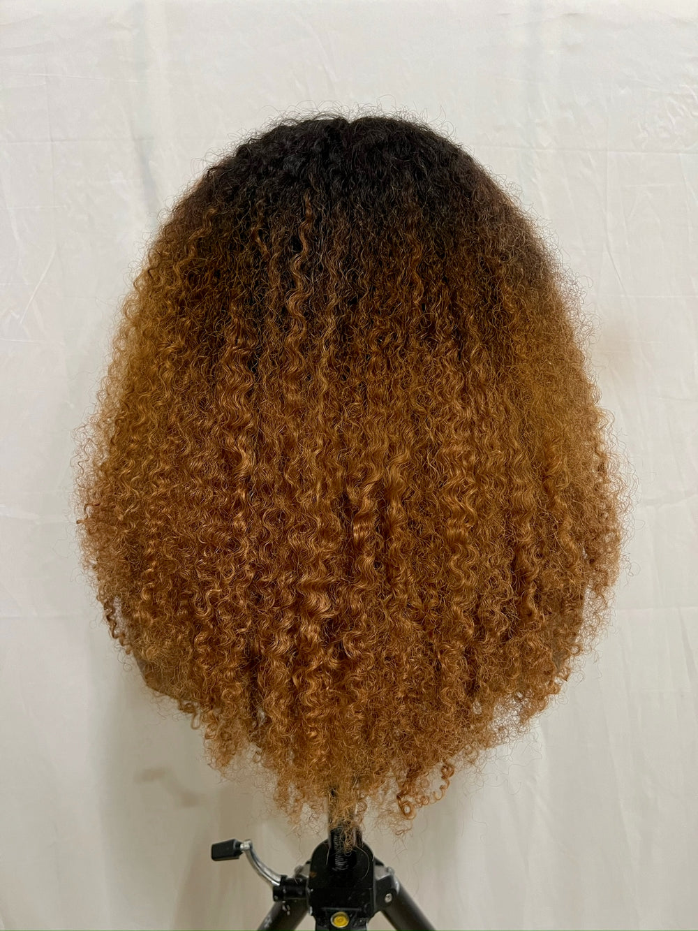 hand bleached color, curtain bangs and is crafted from 100% human kinky hair