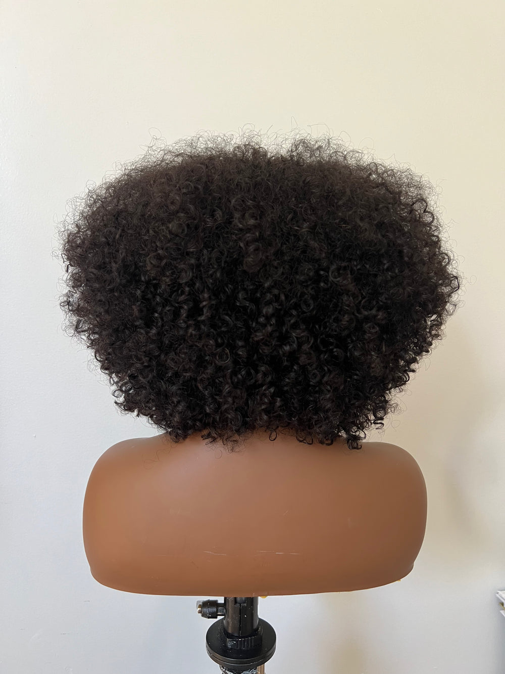 14-inch pre-styled unit features curly textured hair. The 200% density